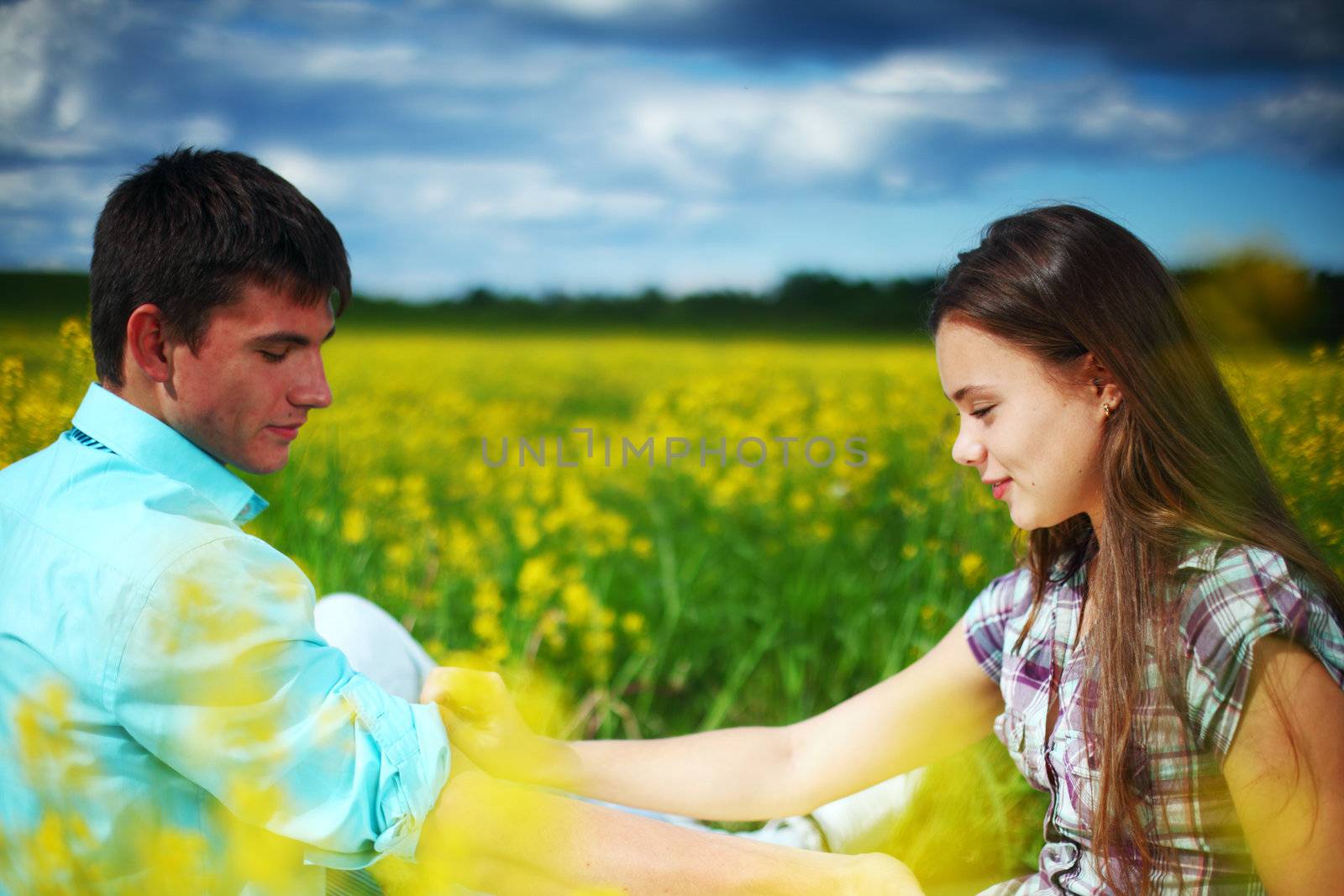 lovers hug on yellow flower field