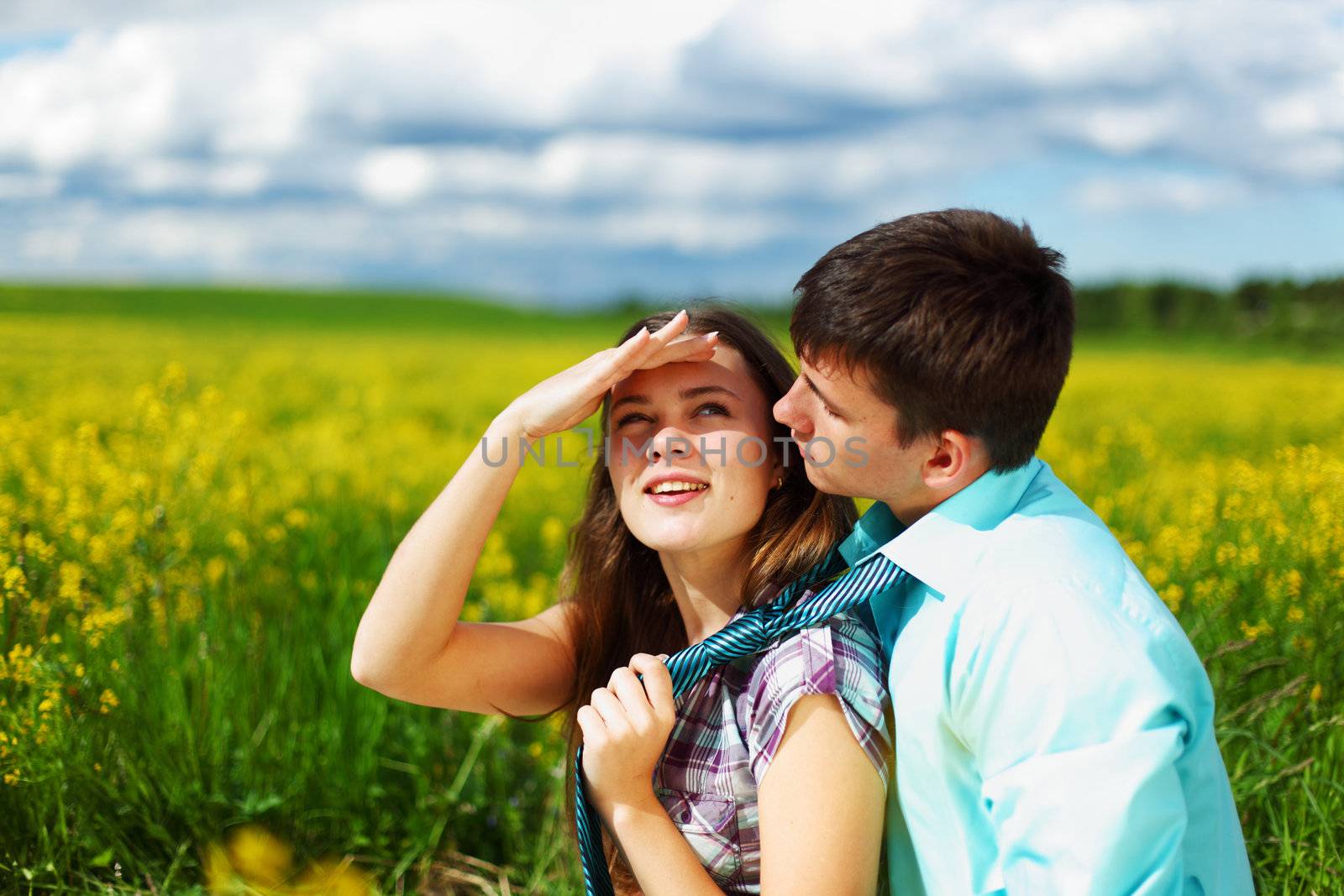 lovers hug on yellow flower field