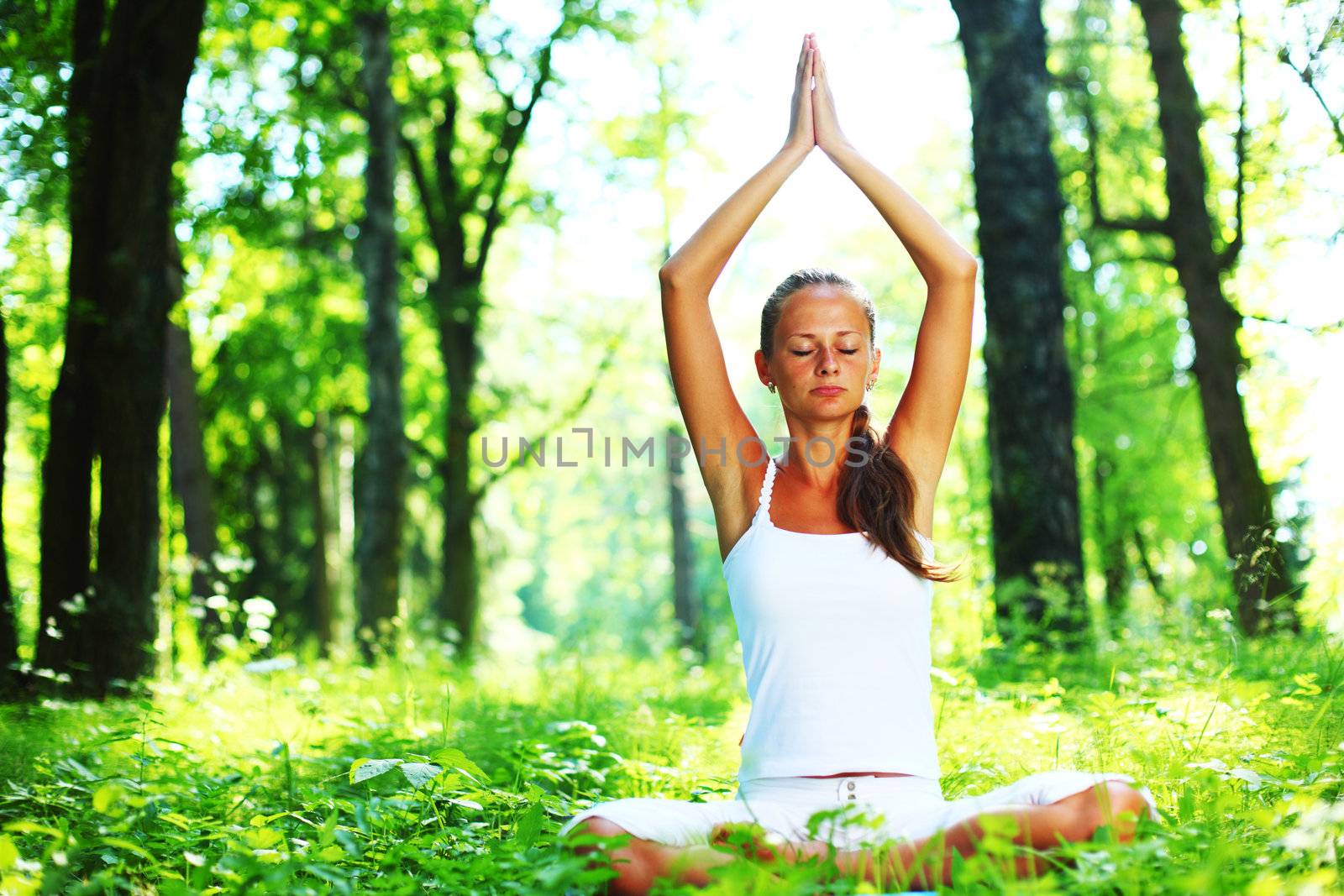 yoga woman on green grass in forest