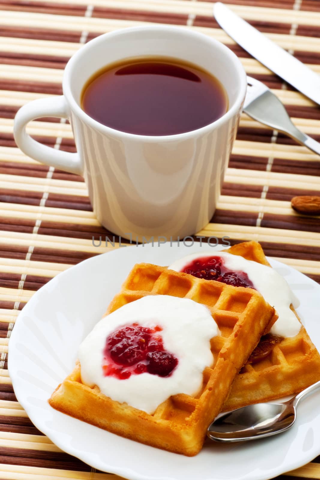 breakfast with soft waffles, sour cream and raspberry