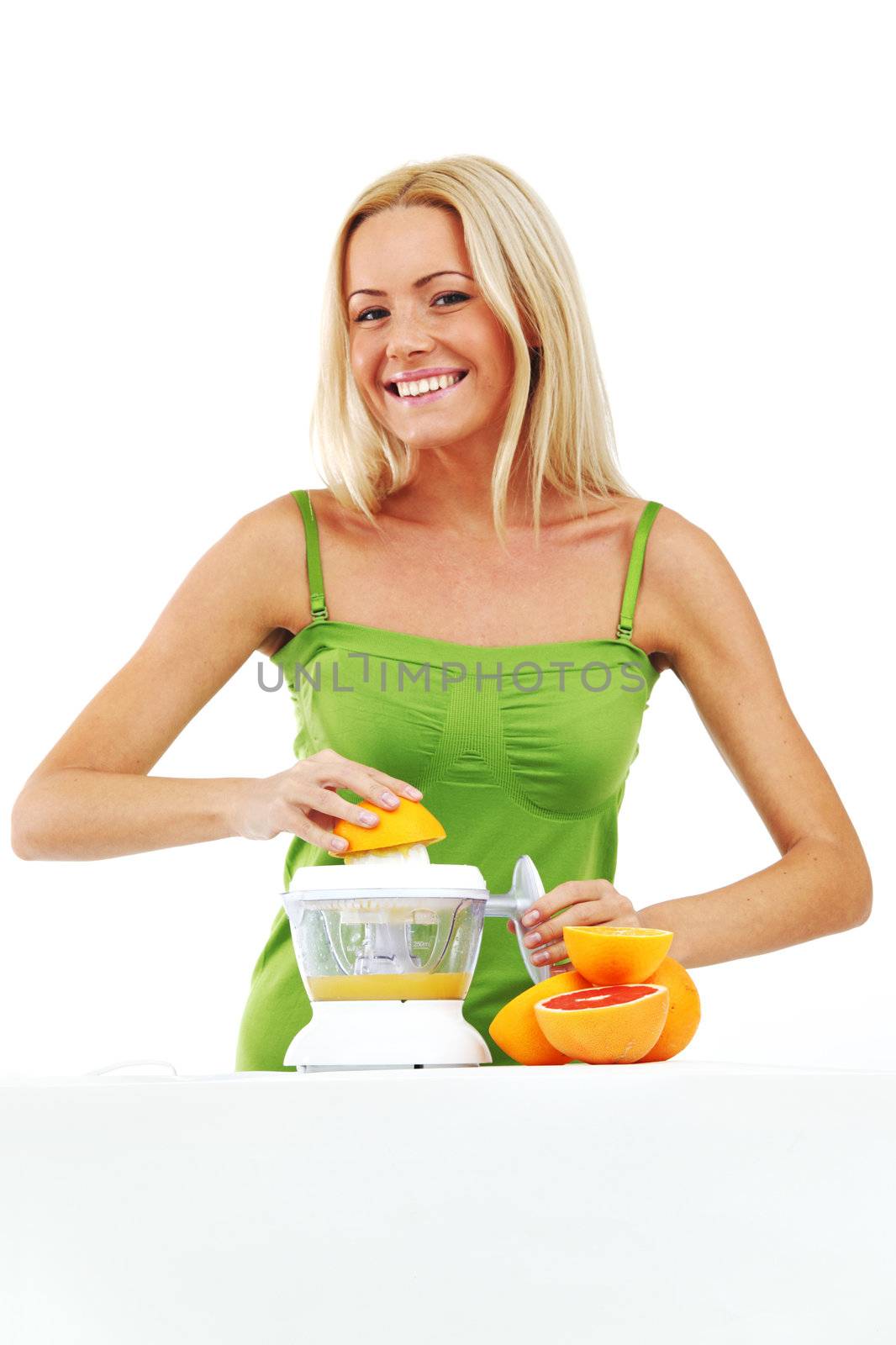 woman squeezes juice by juicer