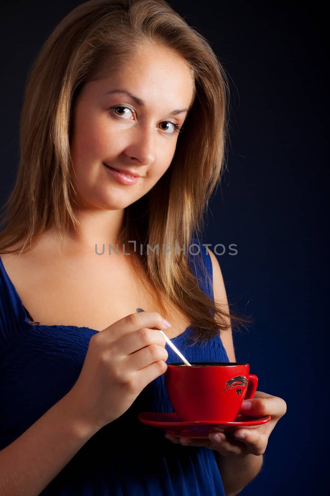 beautiful girl with cup of coffee, blue background