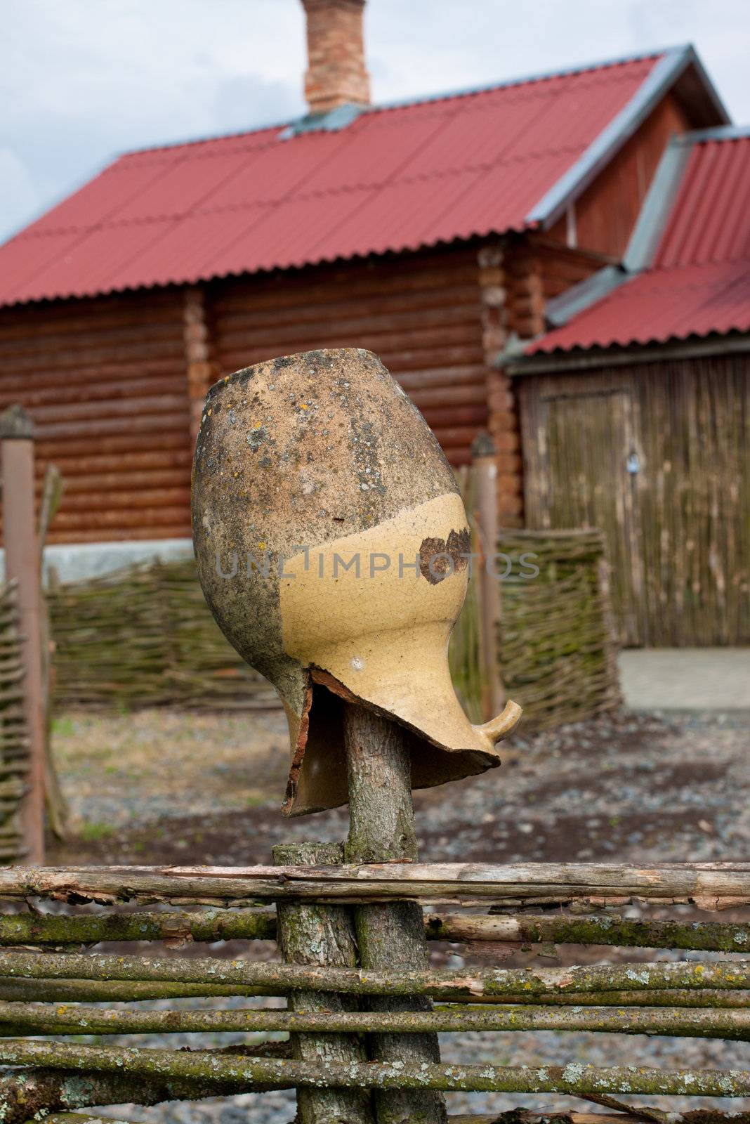 broken jar on village fence