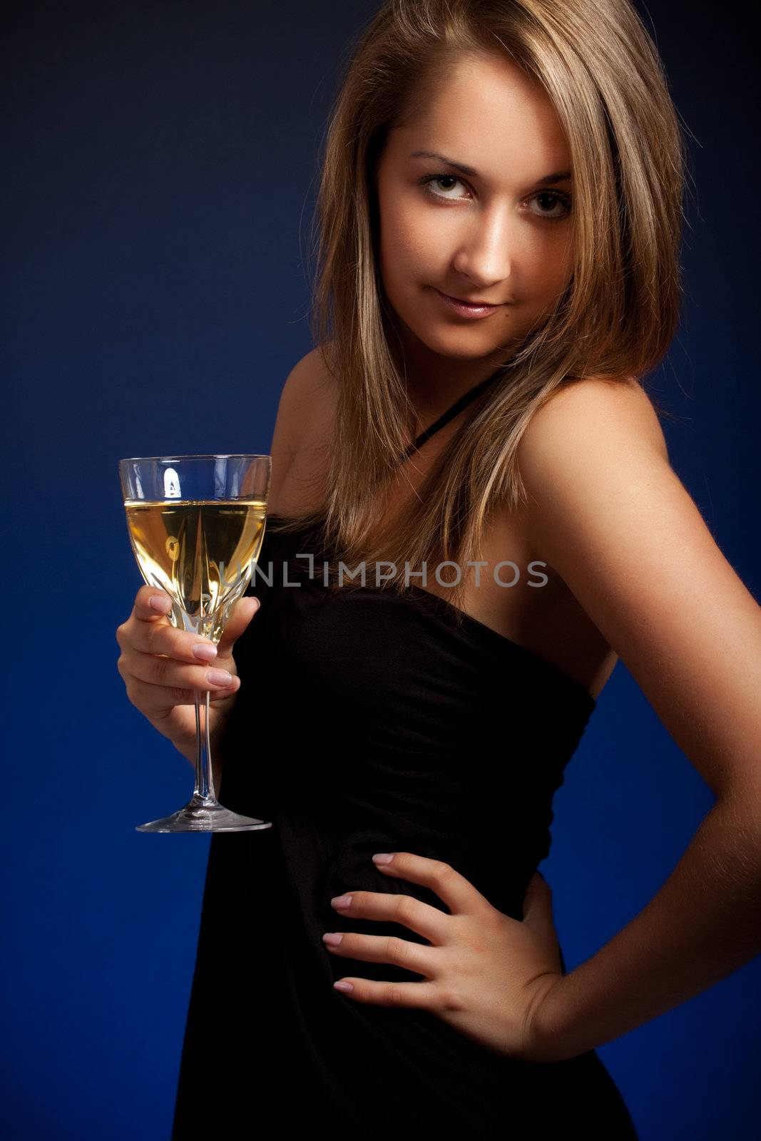 beautiful girl with glass of wine, blue background