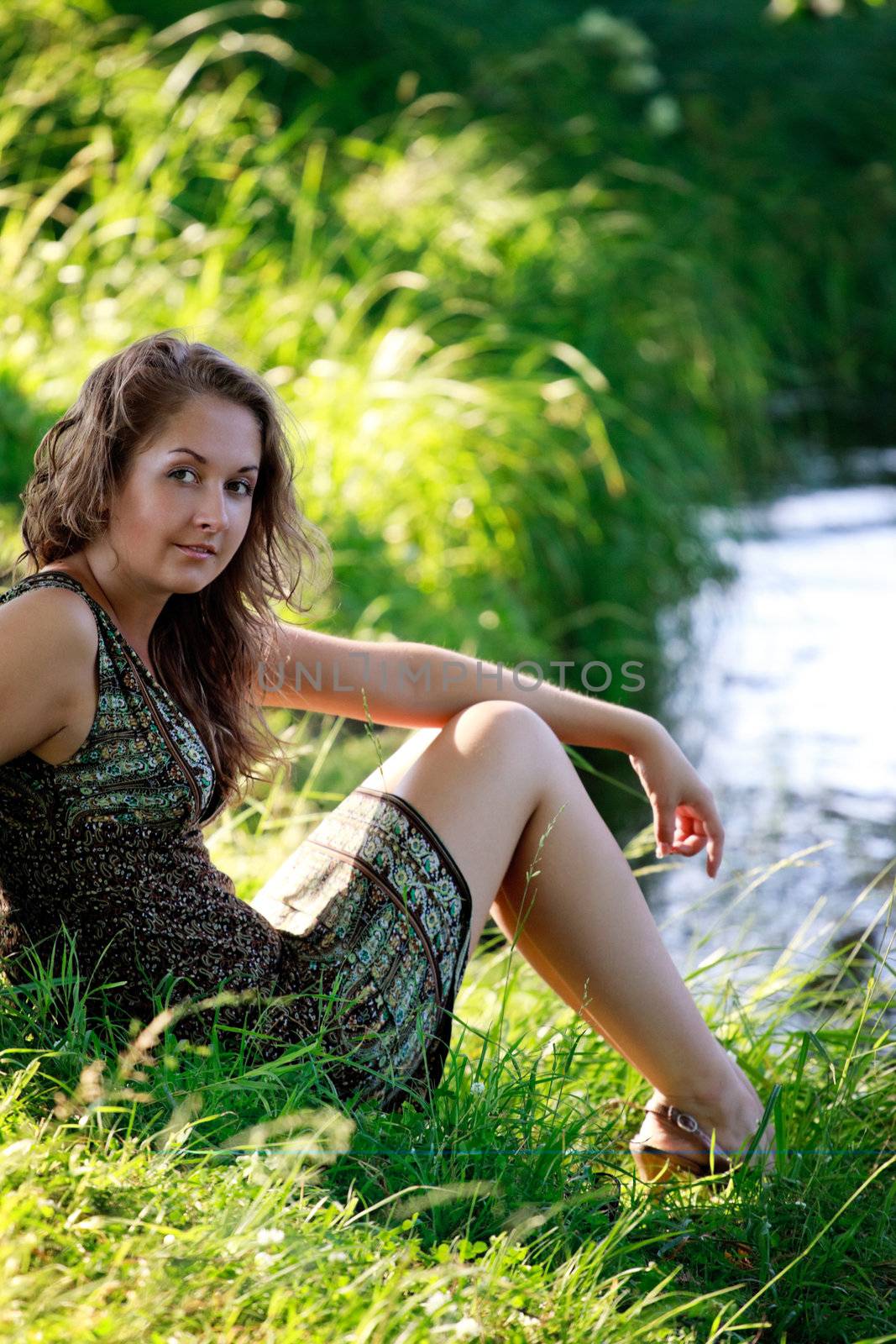 beautyful woman sitting on riverside