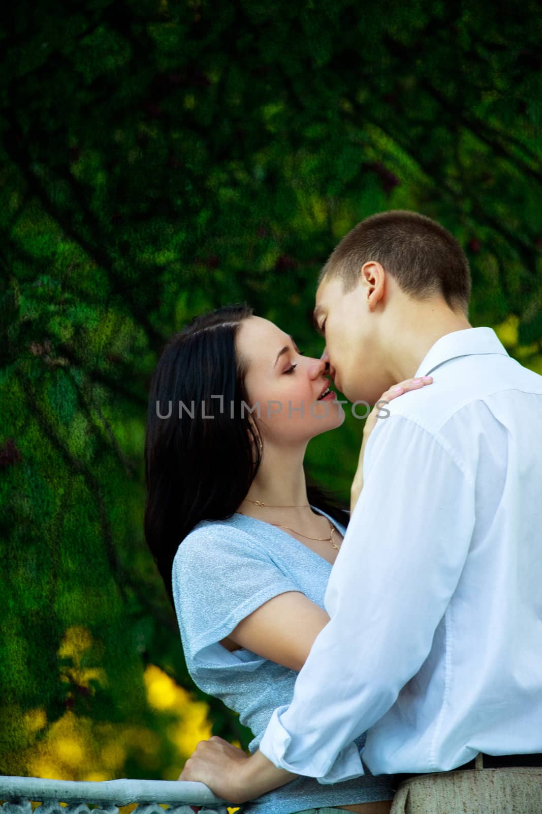 young couple in the park kissing