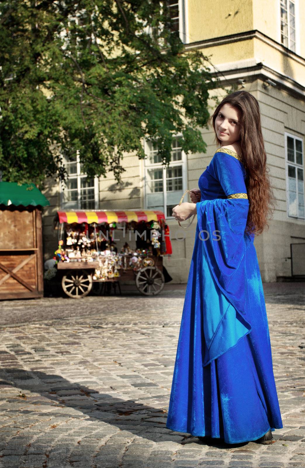 medieval girl on street of old town