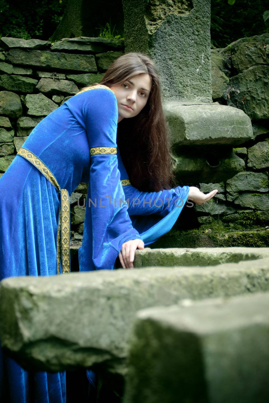 medieval girl next ancient spring