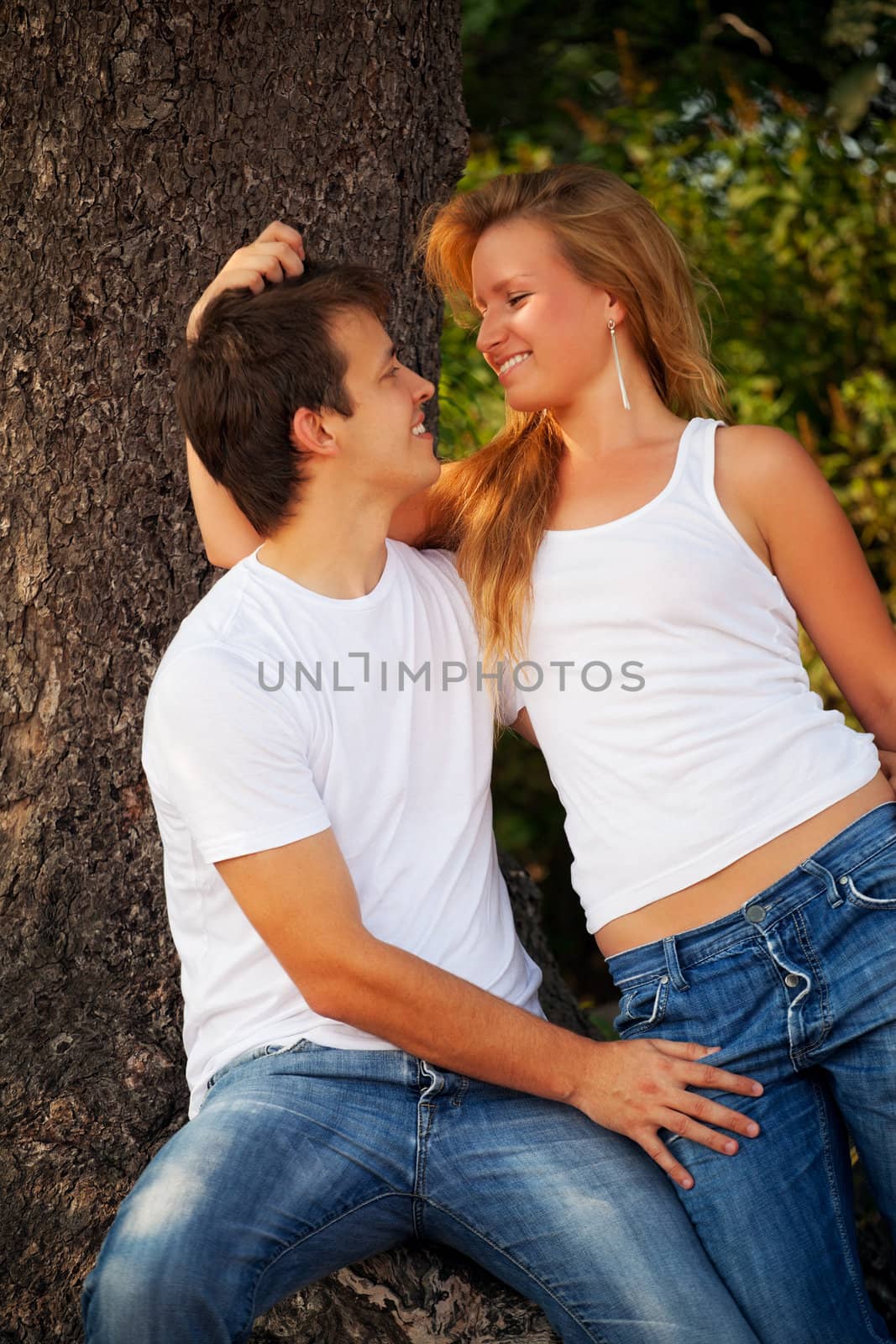 smiling couple next tree by petr_malyshev
