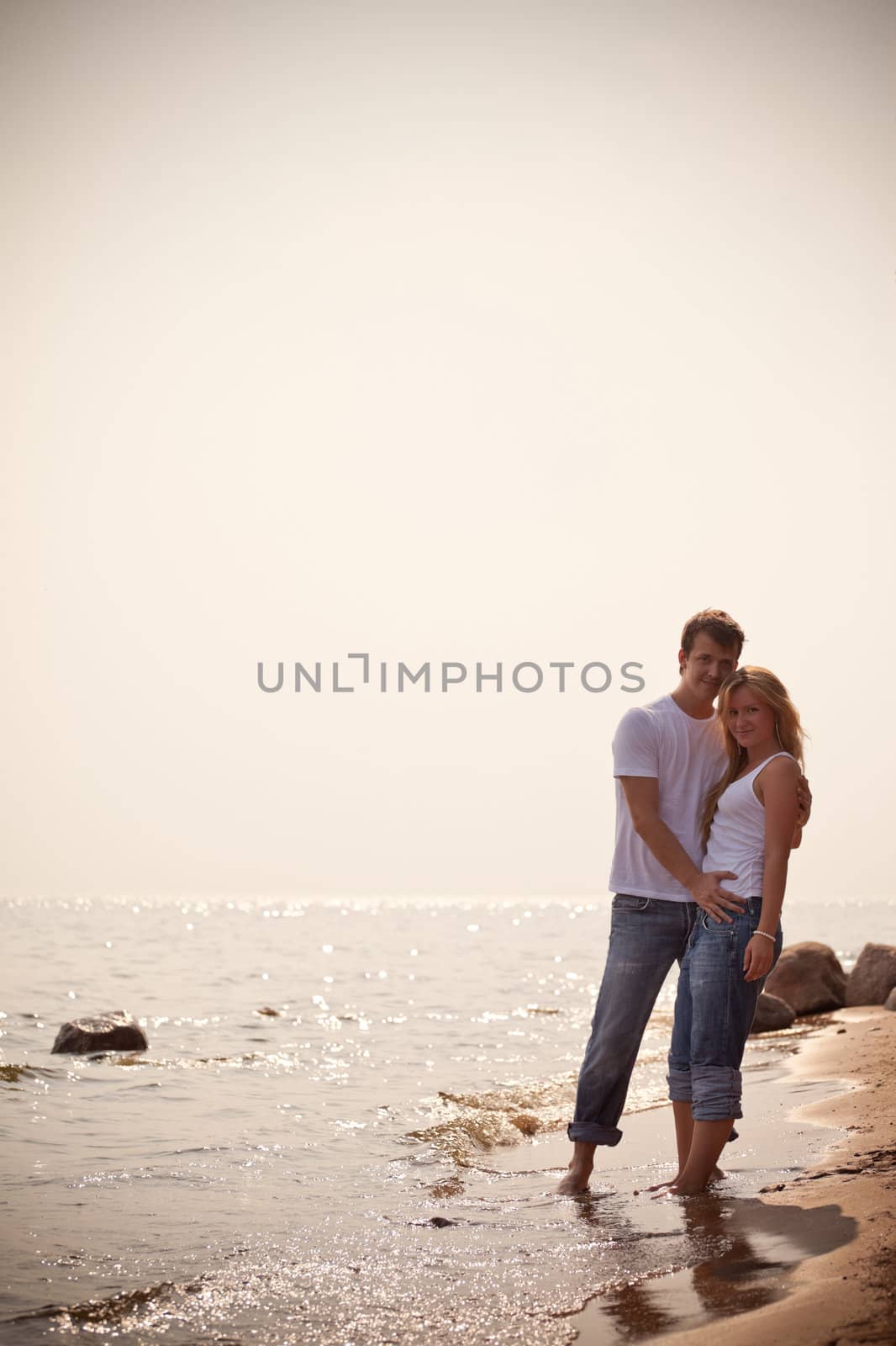 beautiful couple on a seashore, toned