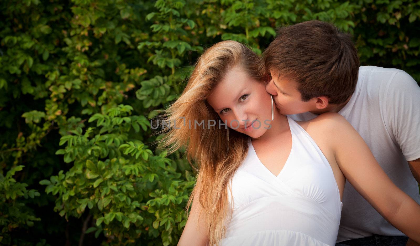 man kiss sly girl in cheek by petr_malyshev