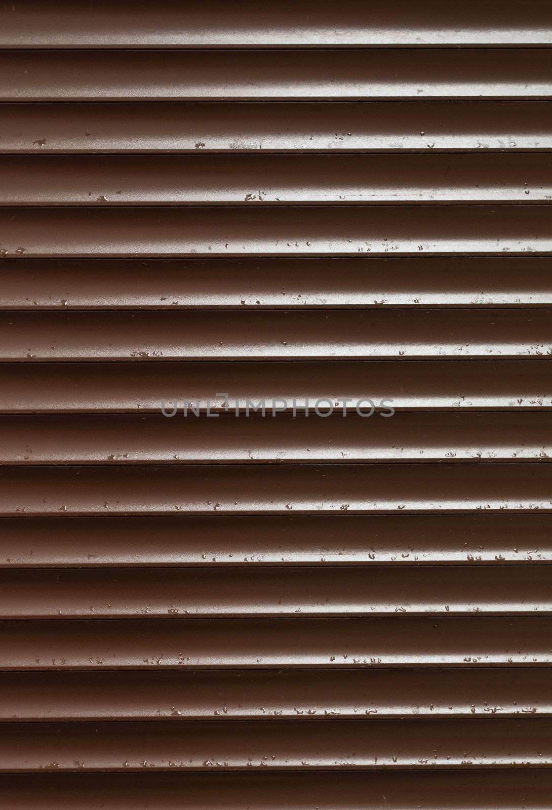 Closeup of Brown Blinds With Rain Drops