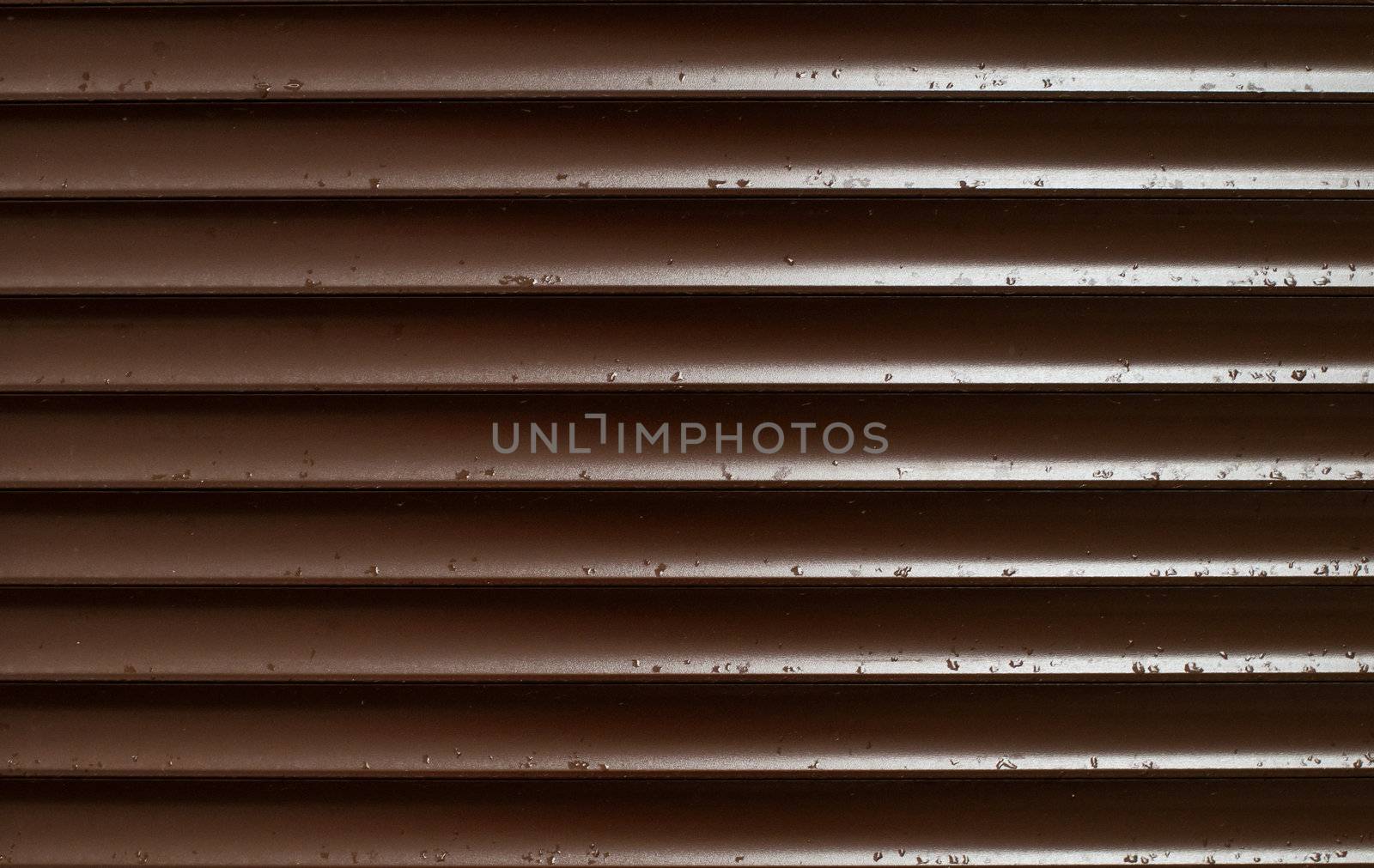 Closeup of Brown Blinds With Rain Drops