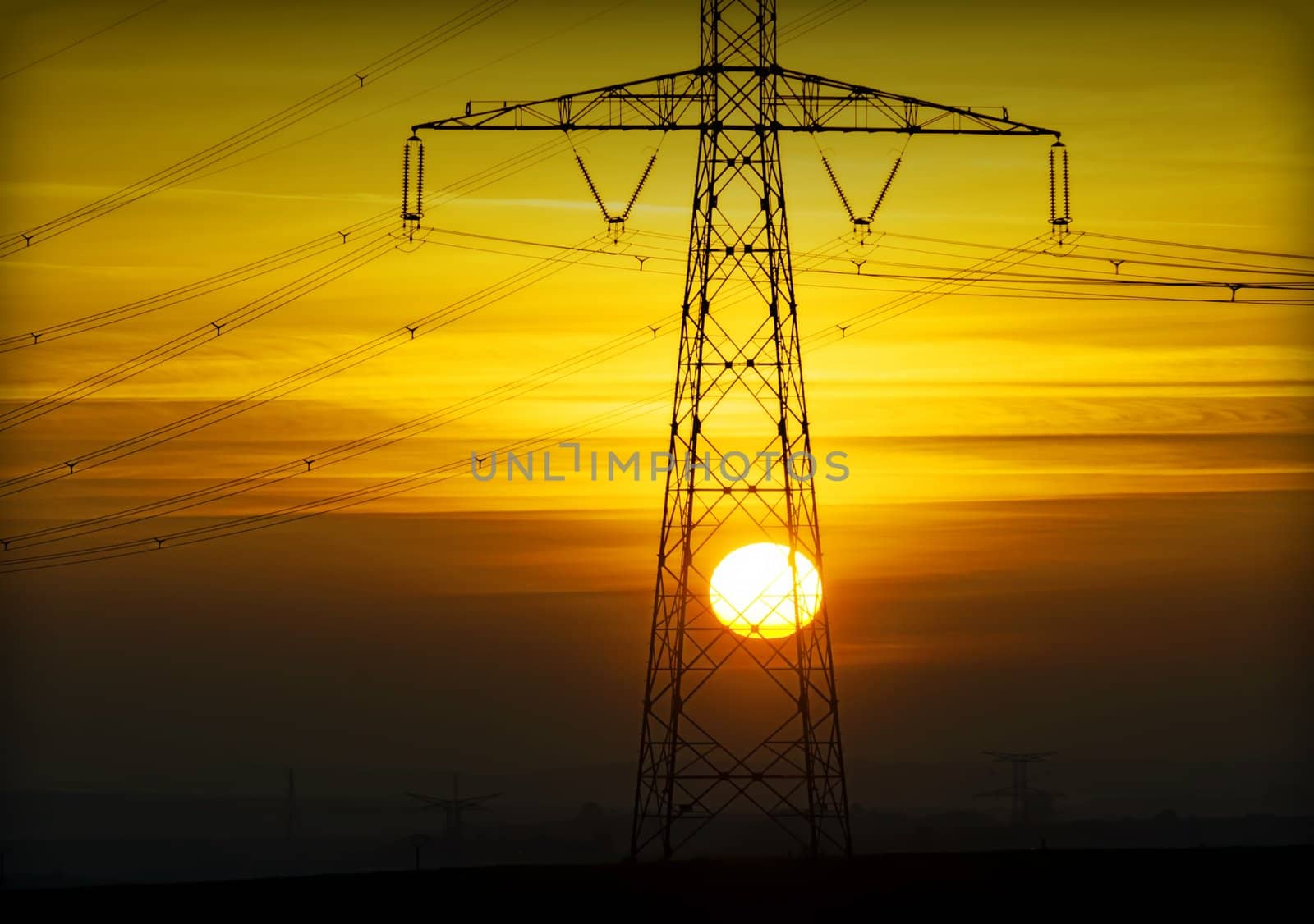 high voltage pylons on sunset background