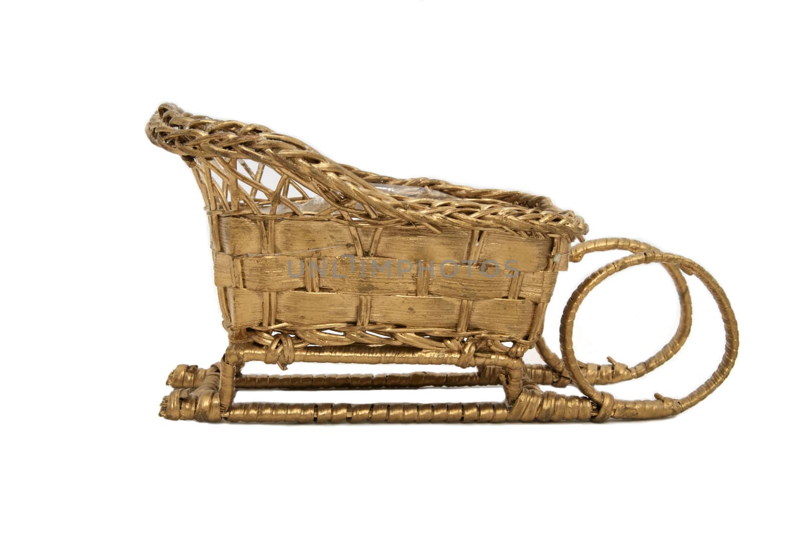 golden wicker sleigh from a vine on a white background