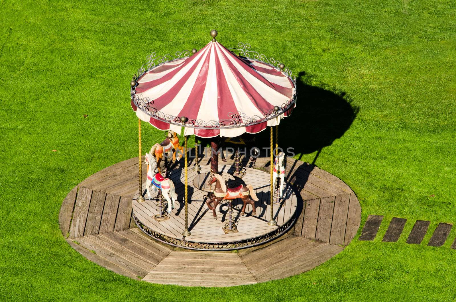 the small carousel in green grass