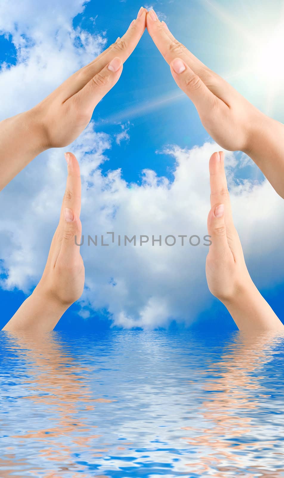 Conceptual home symbol  from human hands on nature background