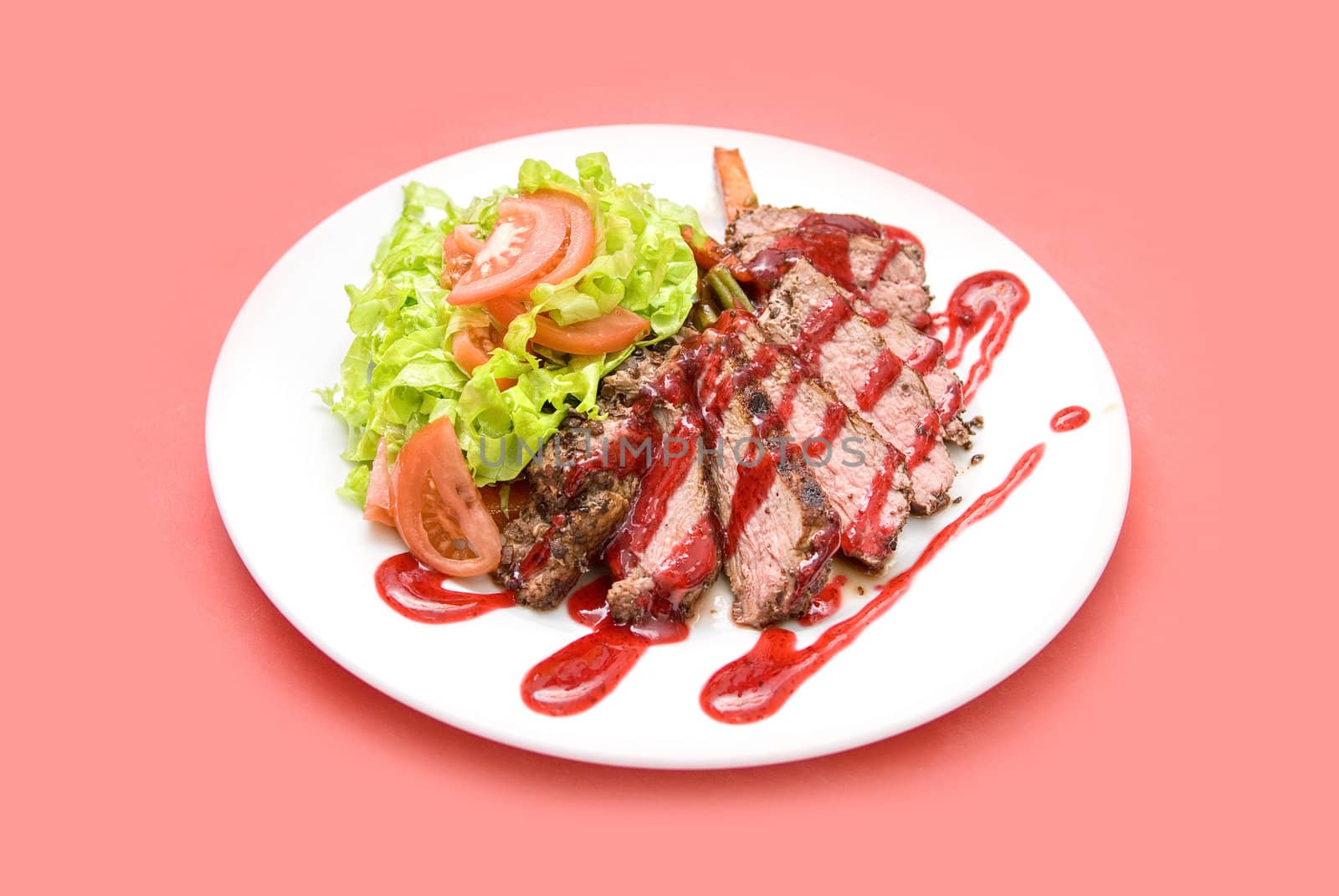 Roasted Beef meat at cranberries sauce with vegetables