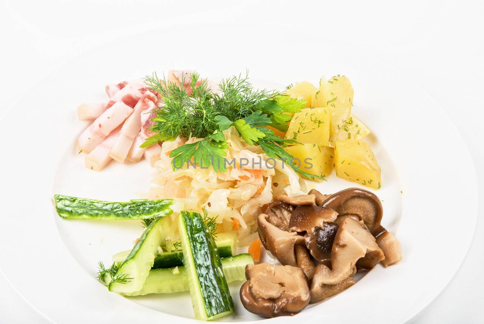 Tasty snacks: potato, fat and vegetables  at plate isolated on a white