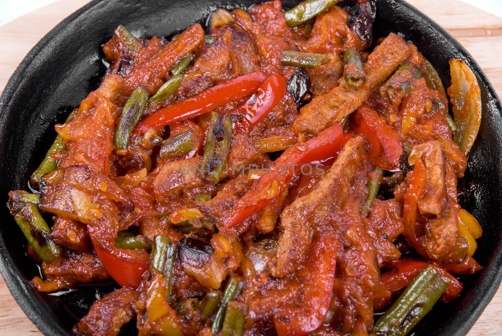 Roasted meat and vegetables at pan isolated on a white background