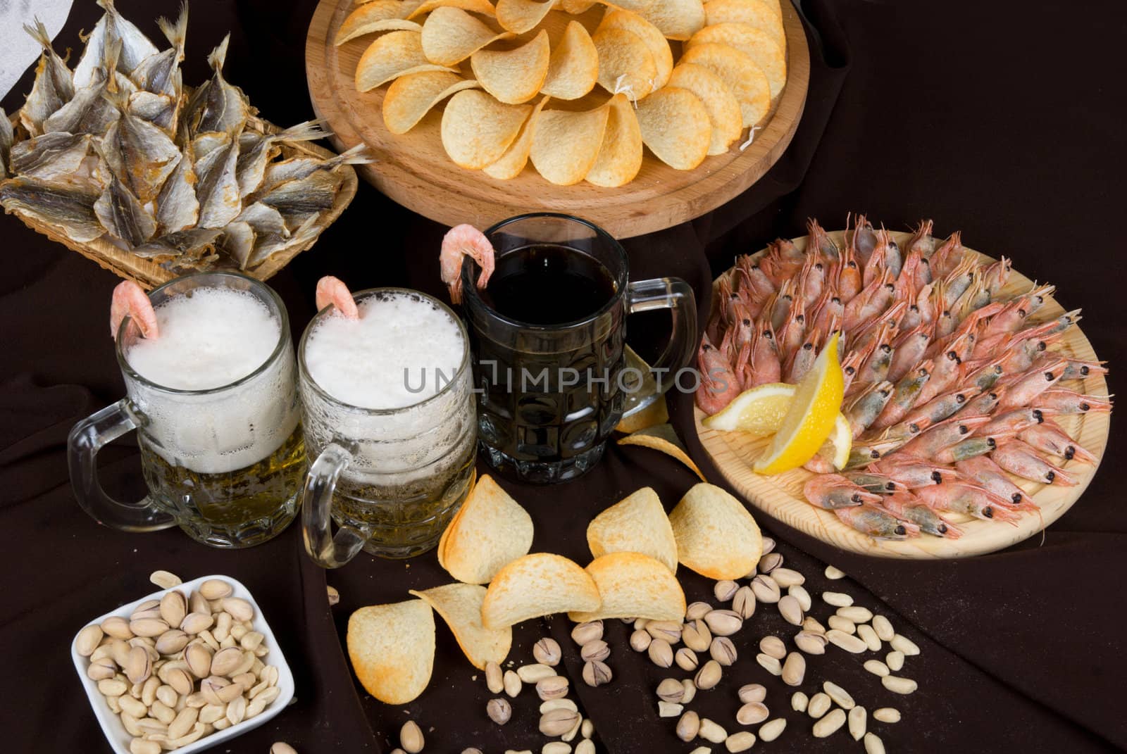 Beer and snacks set: chips, pistachio, shrimp and fish