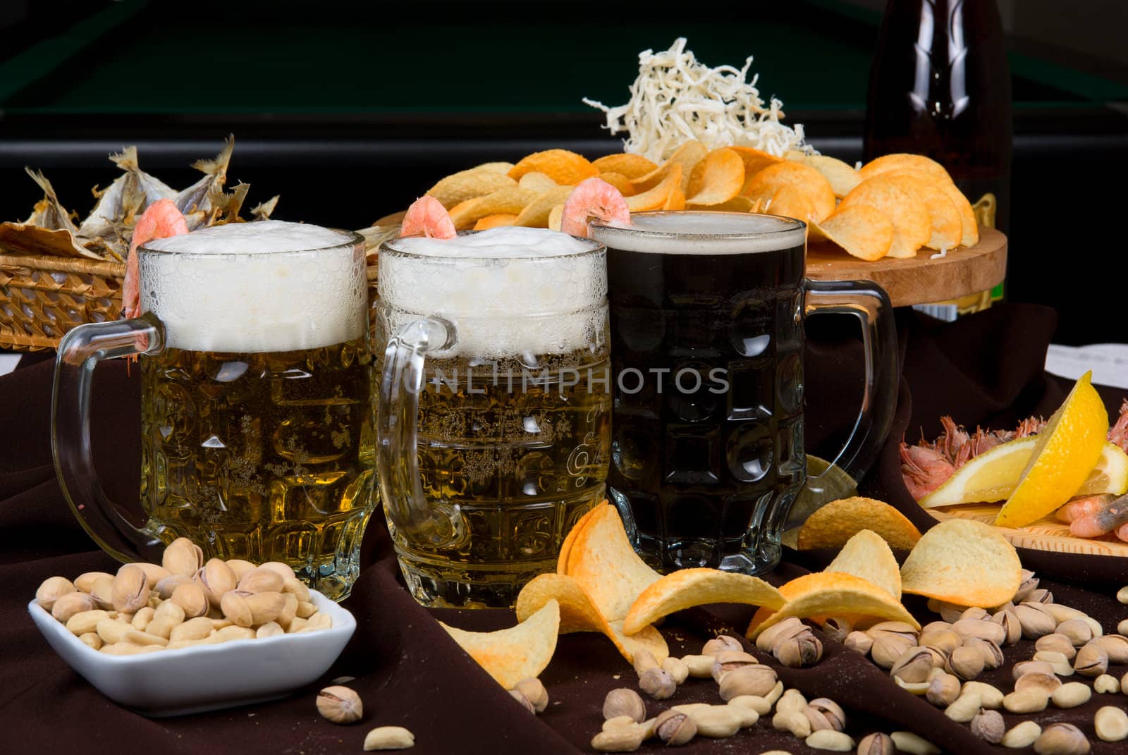 Beer and snacks set: chips, pistachio, shrimp and fish