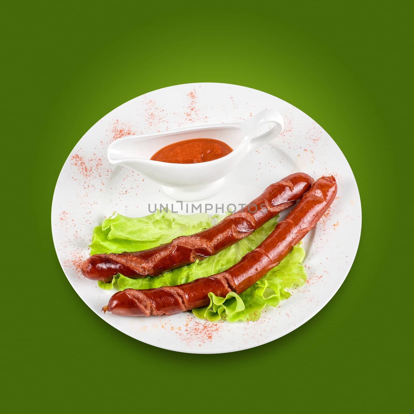 grilled sausage with lettuce and sauce on green background