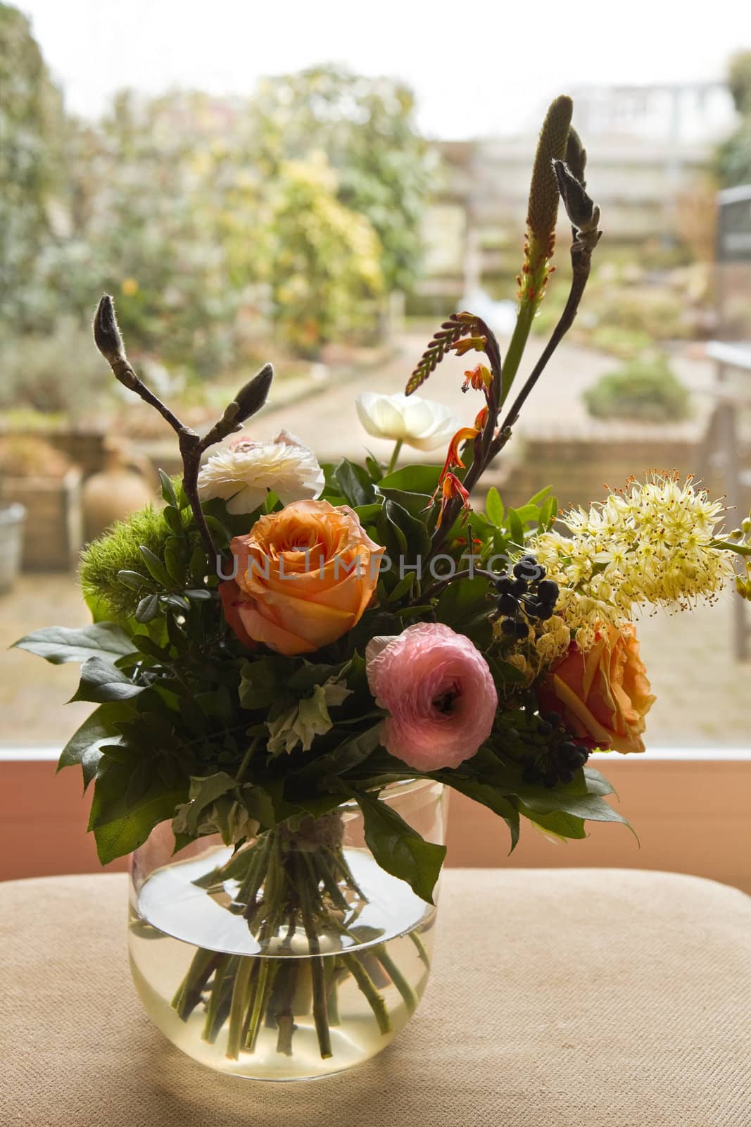 Bouquet of flowers in window with view to garden in background