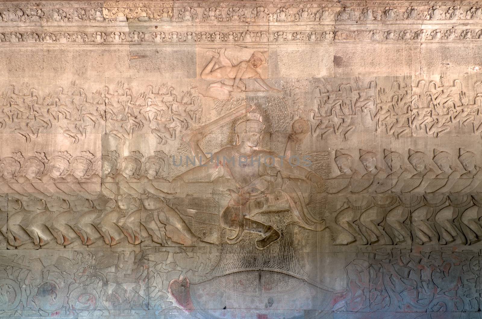 The bas-relief of the Churning of the Sea of Milk shows Vishnu in the centre, his turtle Avatar Kurma below, asuras and devas to left and right, and apsaras and Indra above. Angkor Wat. Cambodia