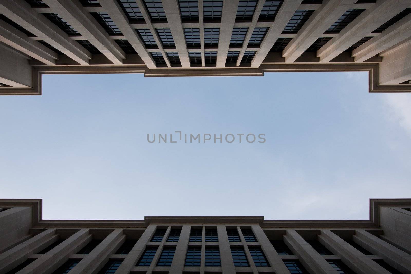 Sky between tall buildings. One corner between two buildings spaced tall buildings to clear skies.