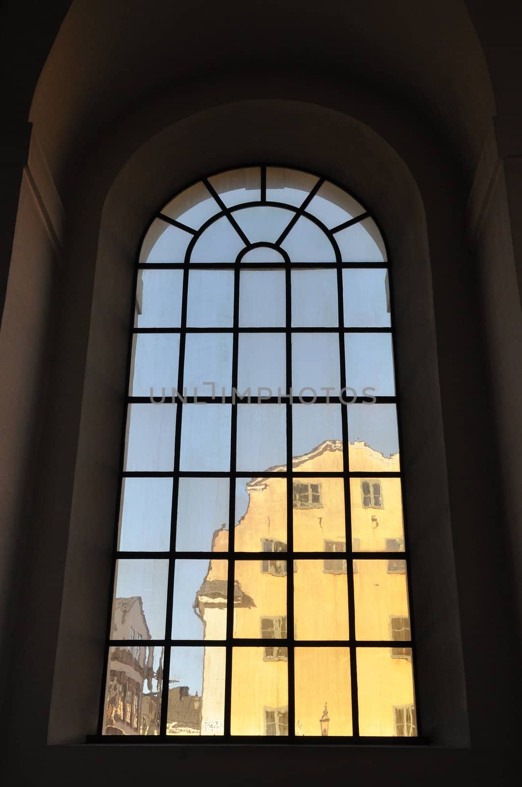 Building seen through a hand made glass of a church window.