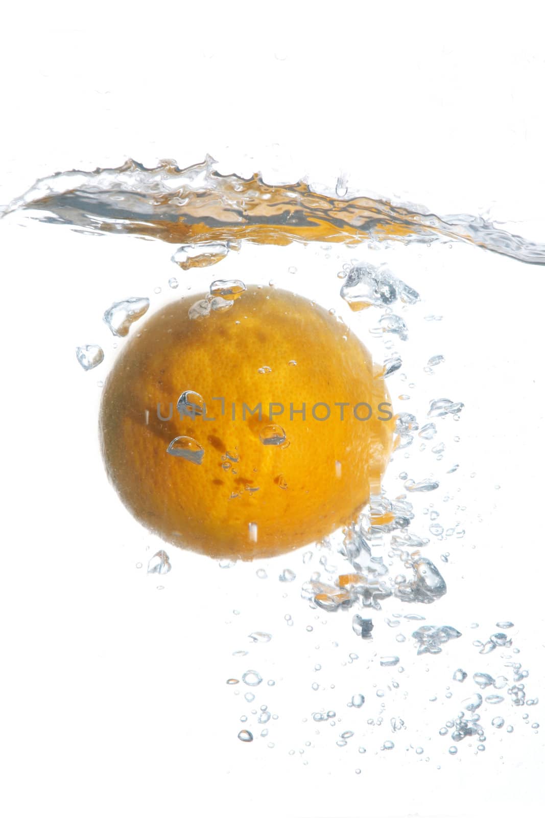 An image of orange falling in water