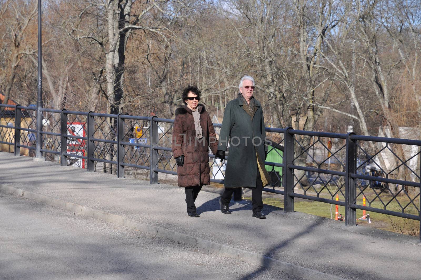 Older couple on a walk holding hands.