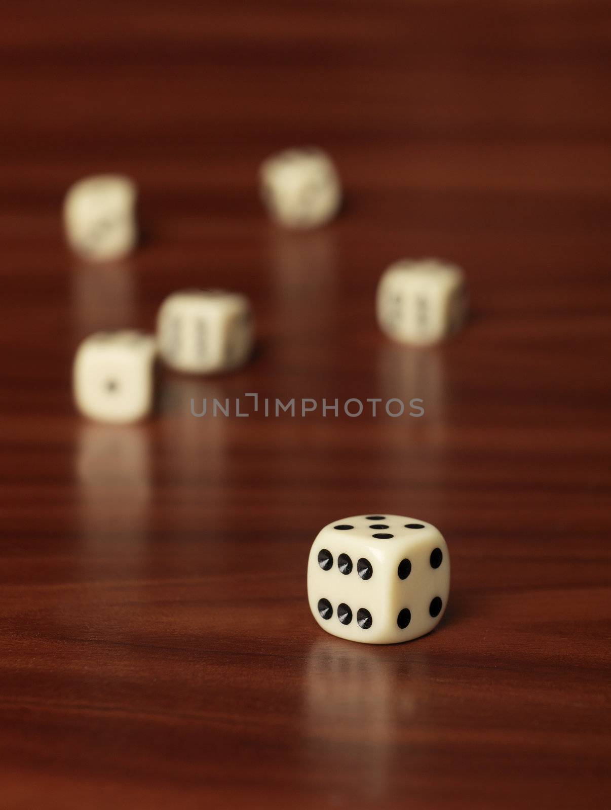 Dices with selective focus on teak background