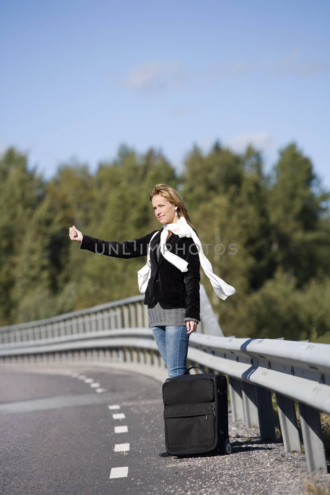 Hitchhiking woman alone at the side of the road