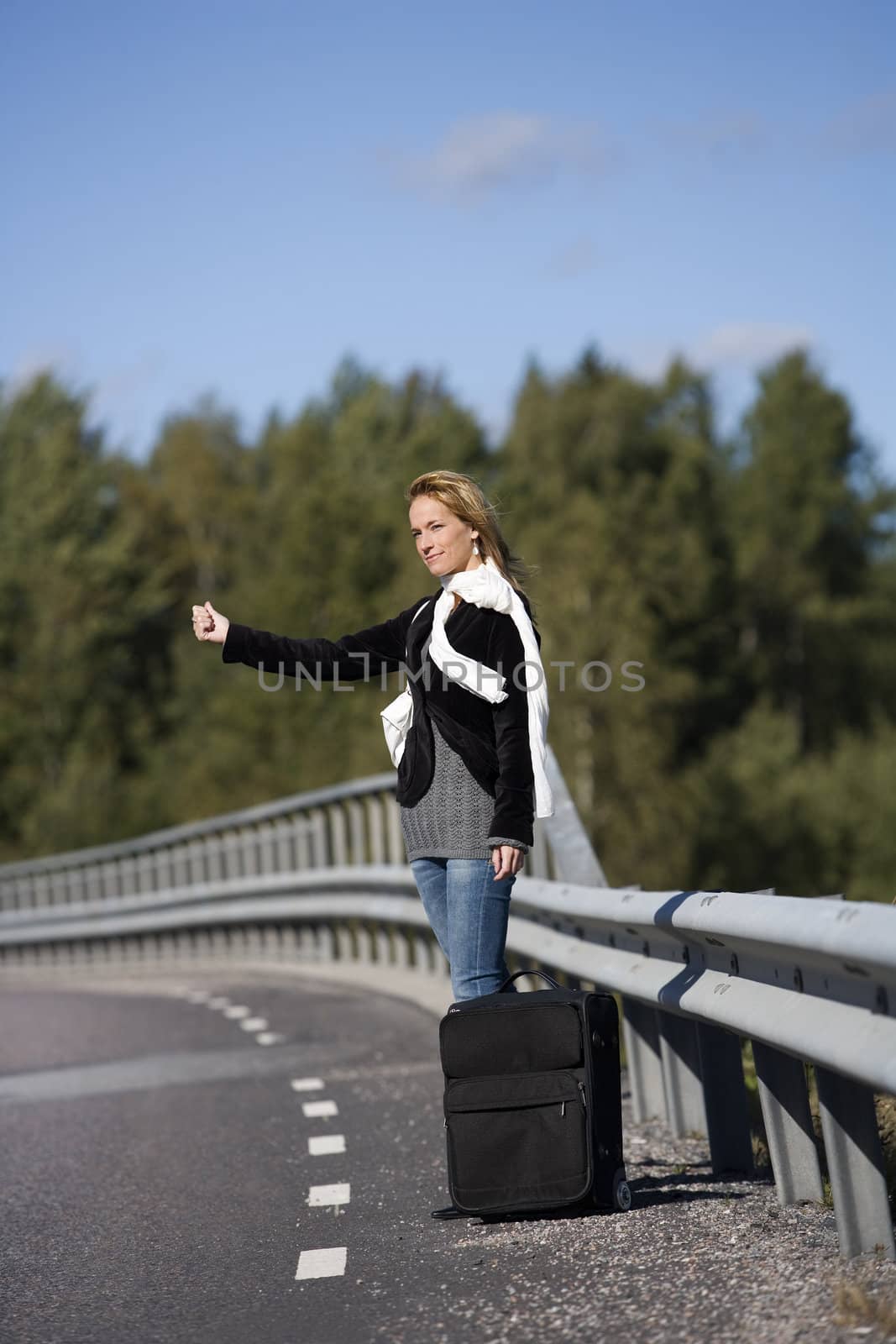 Hitchhiking woman alone at the side of the road