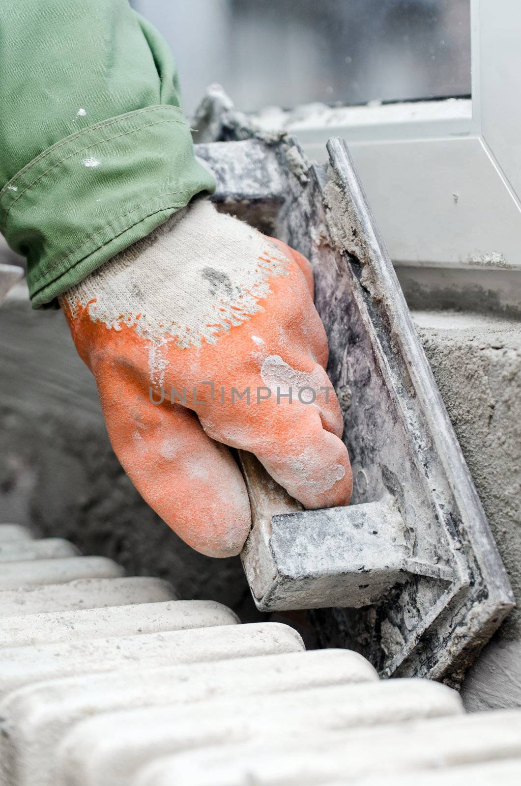 renovation - workers hand captured while finishing works around replaced window, Selective focus