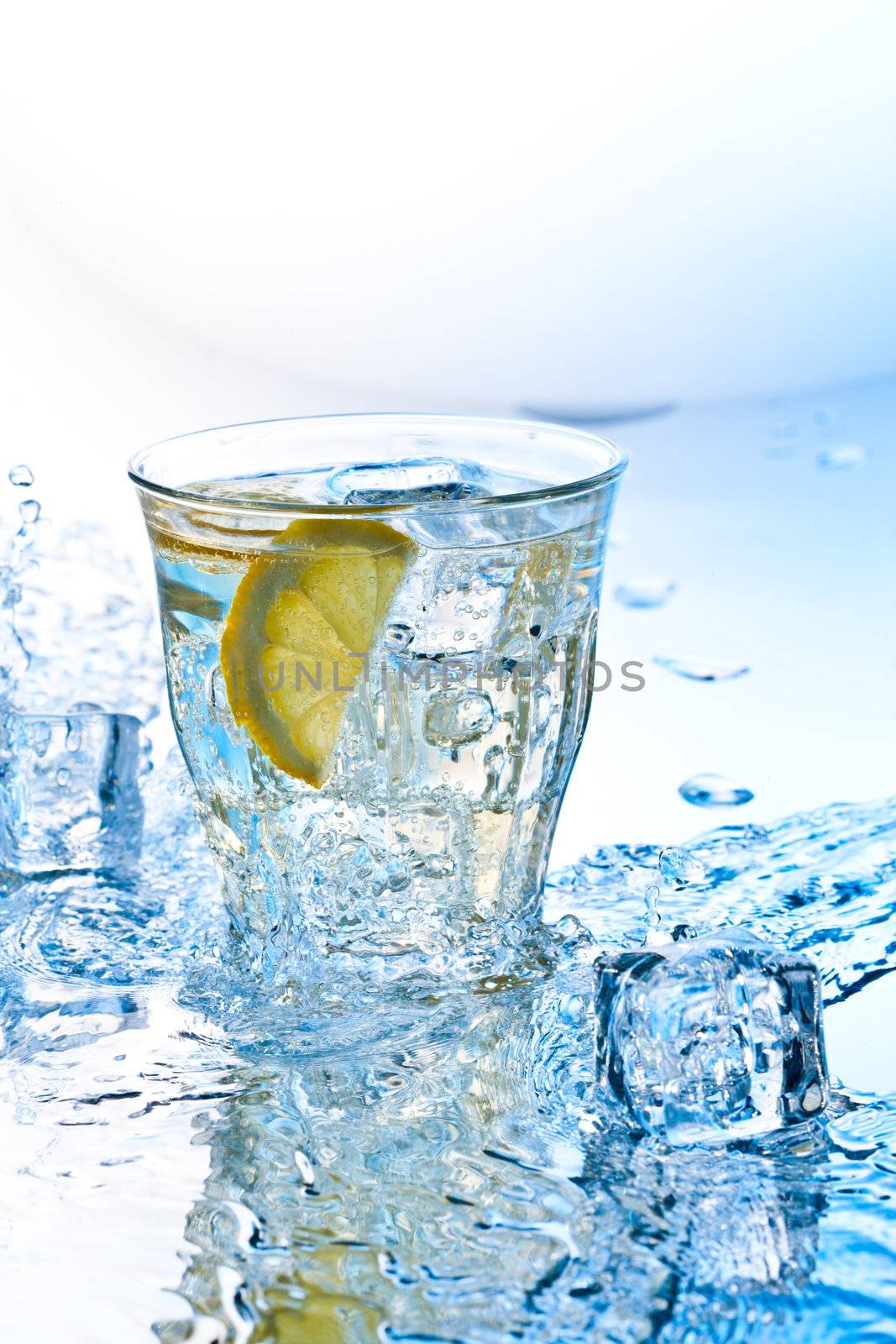 cold soda drink with ice and lemon slashed by water