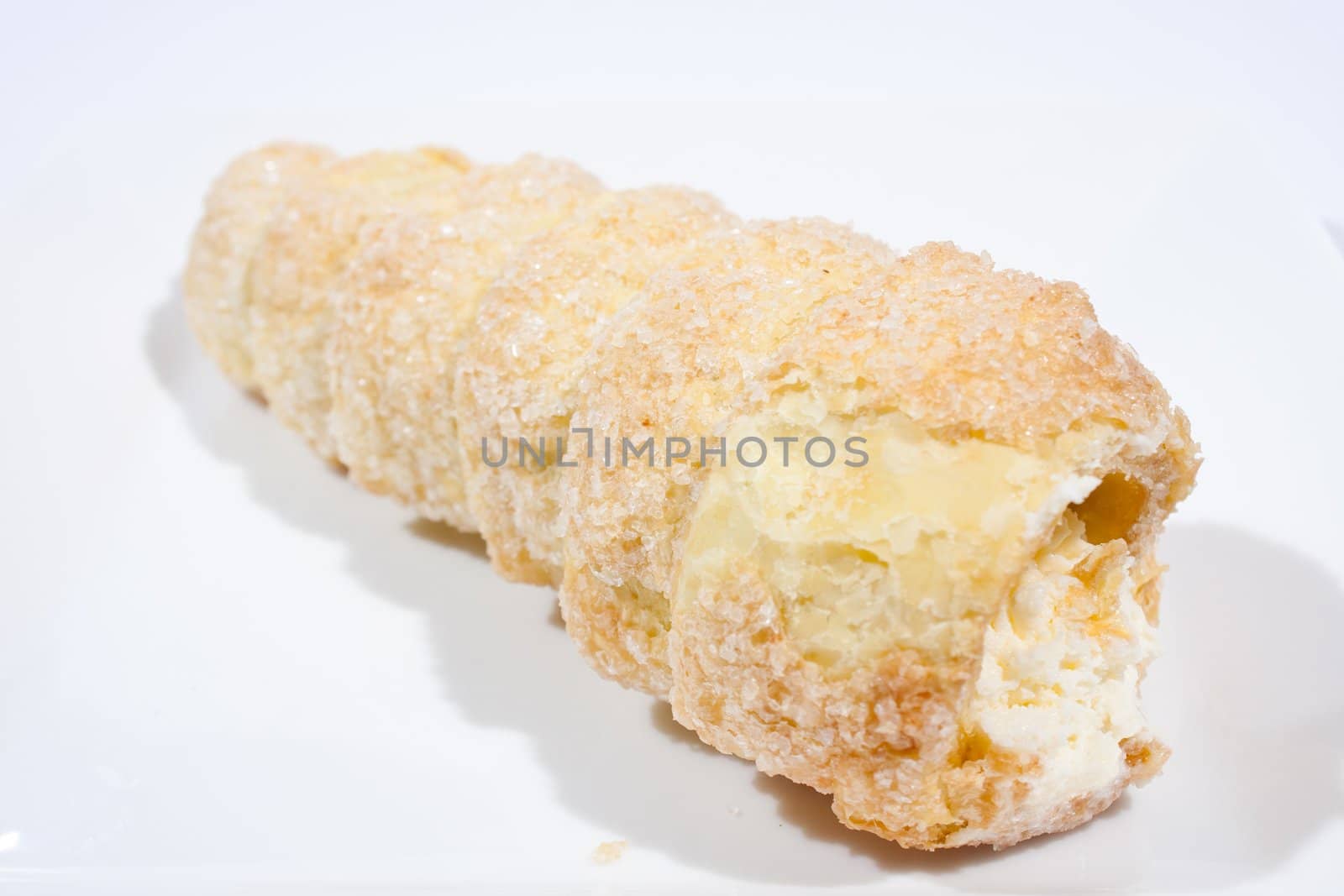 Hard bread with cream Form of a spiral The white background.