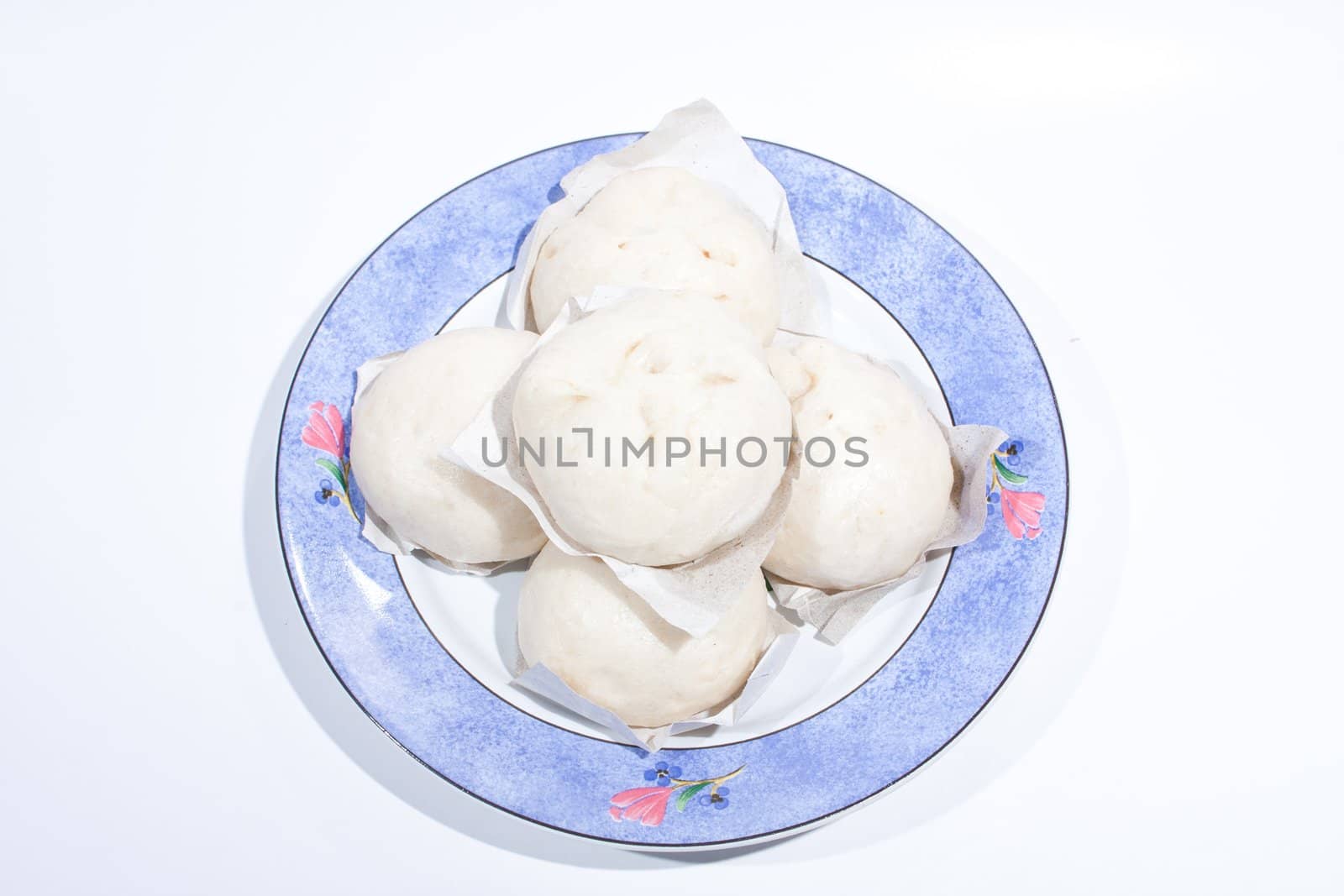 Steamed pile on the plate. Arranged on the plate insert. Placed on a white background.