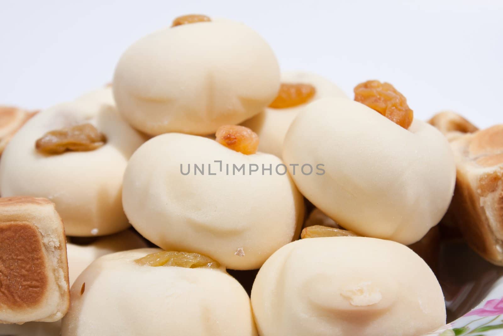 Thai dessert Moji Thai desserts and sweets to roll one more. Taste sweet. Arranged on the plate insert. On a white background.