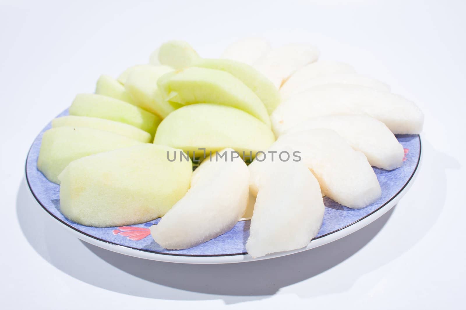 Apples, peeled and wheat. Sort palatable Arranged on the plate insert. On a white background.