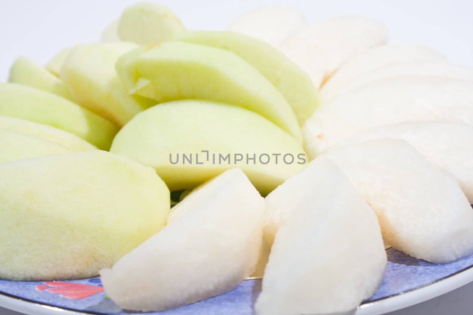 Apples, peeled and wheat. Sort palatable Arranged on the plate insert. On a white background.