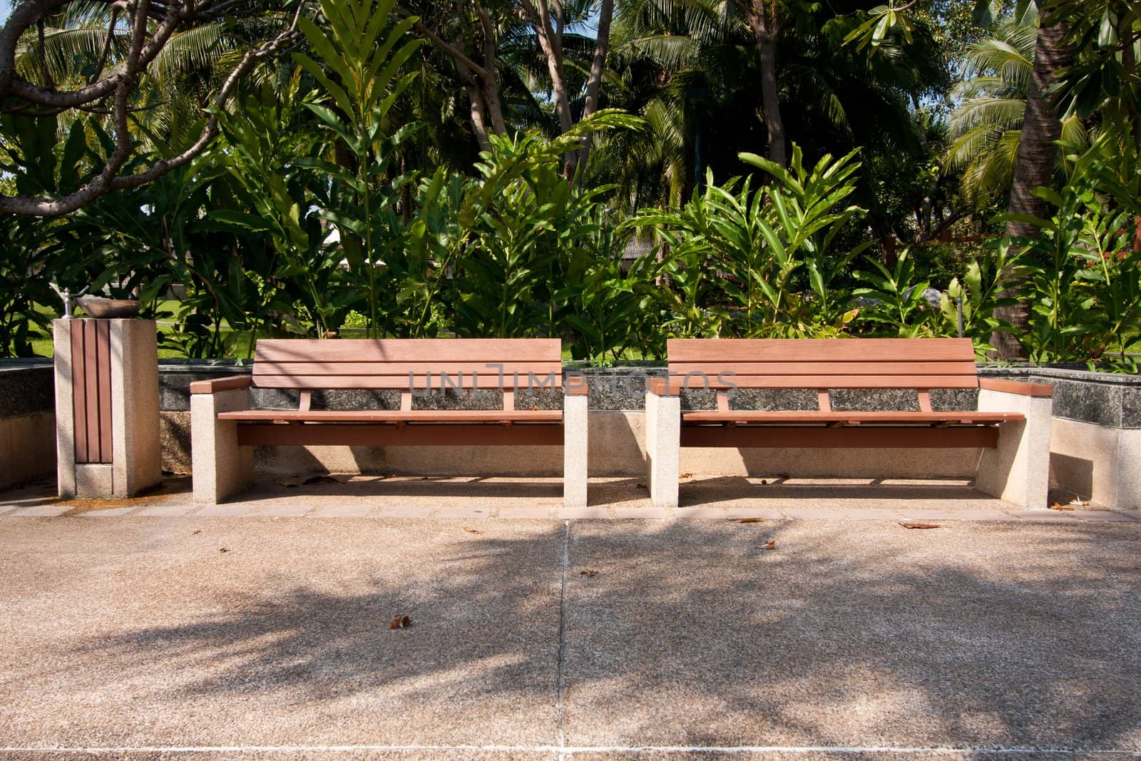 Wooden bench in the park on your holiday tree shade.