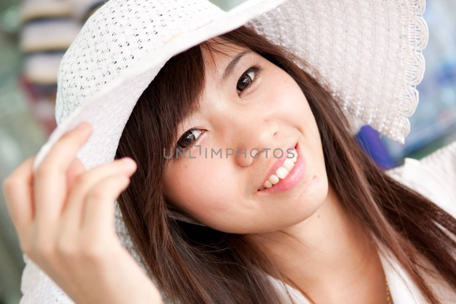 smiling young thai girl and white hat in travel.