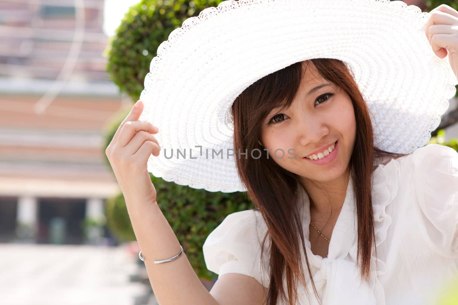 smiling young thai girl and white hat in travel.