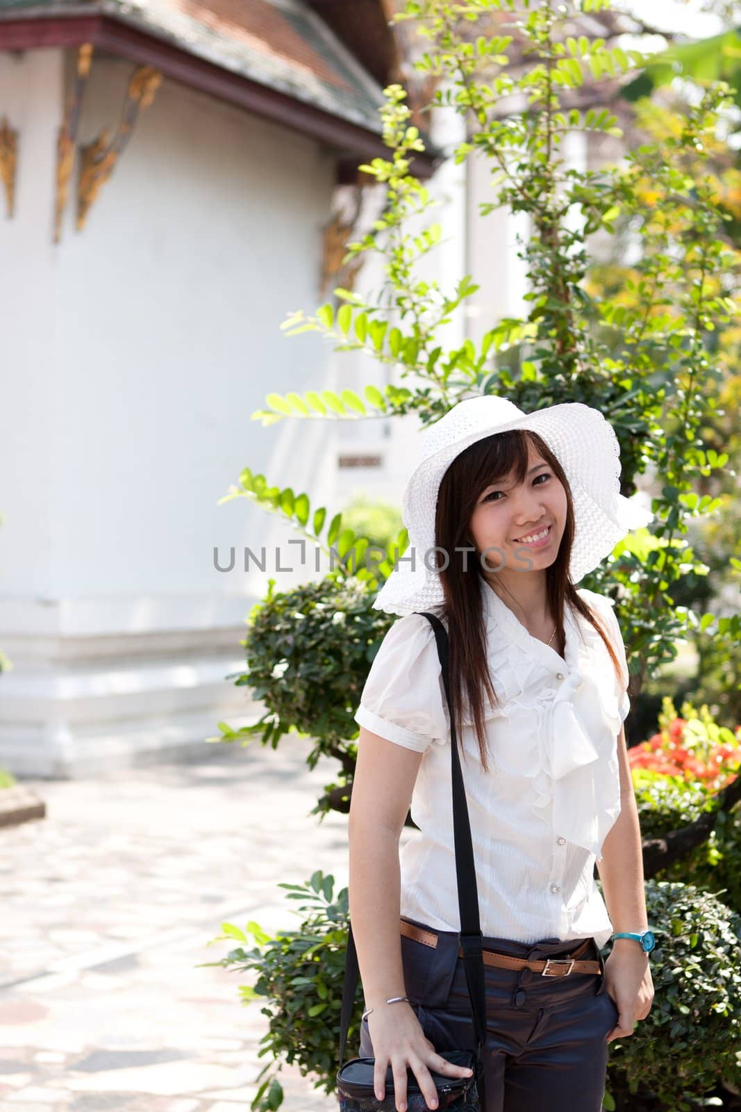 smiling young thai girl and white hat in travel.