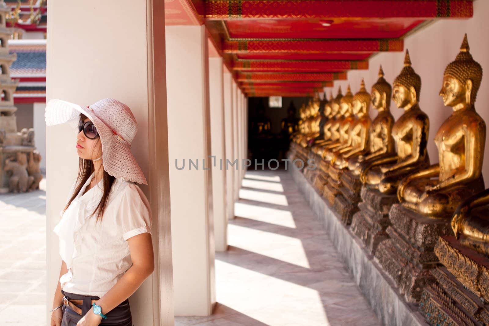 smiling young thai girl and white hat travel in temple thai