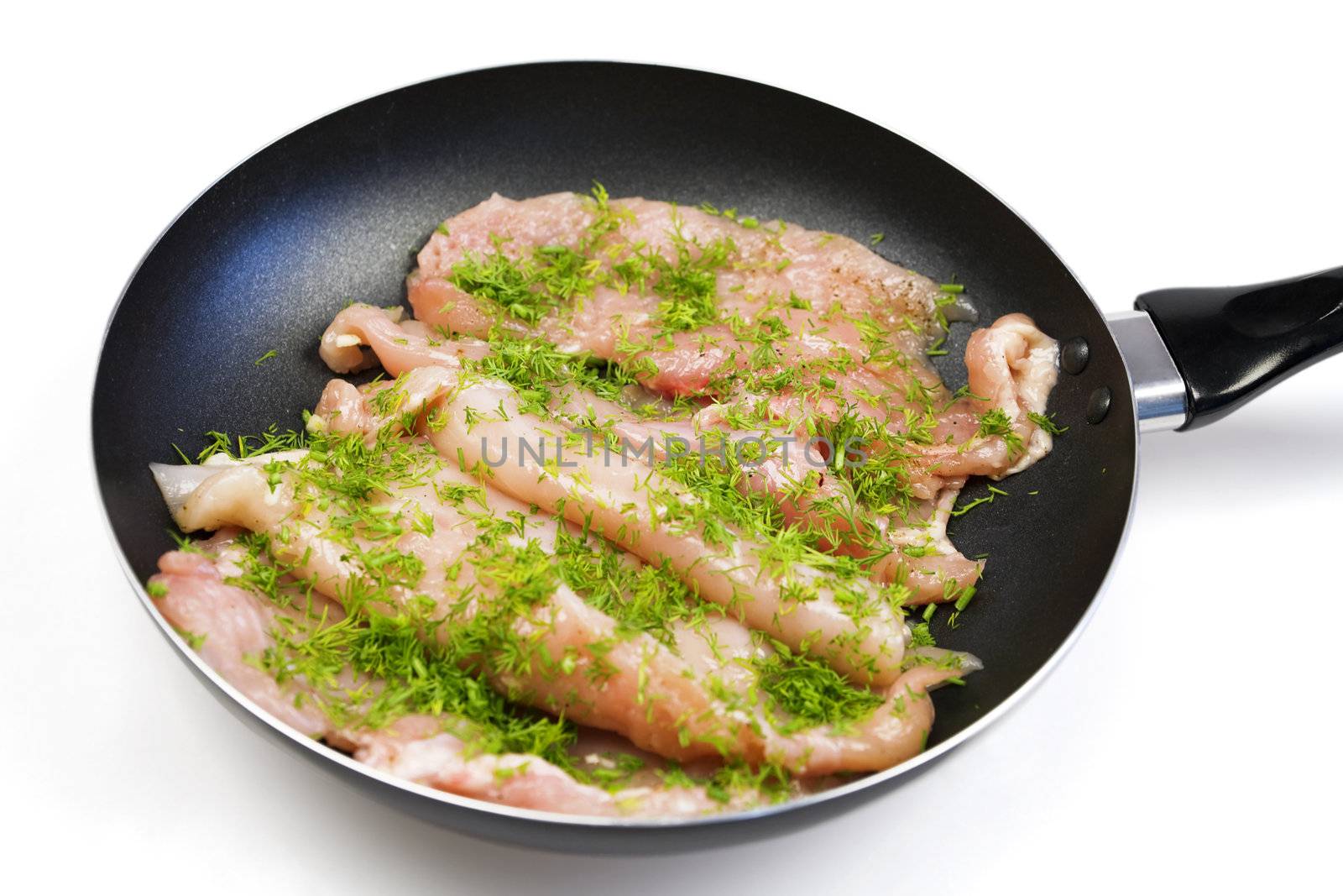Raw chicken meat on a frying pan ready for a frying