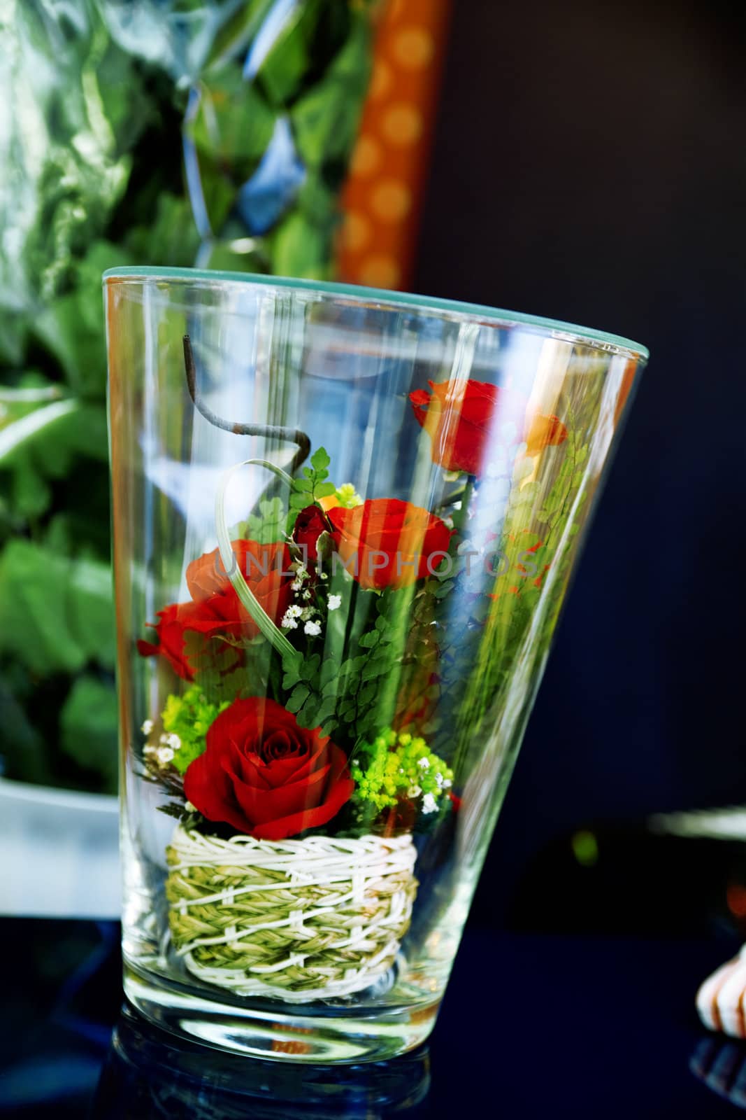 Small bouquet of roses in a glass as a romantic gift to wedding